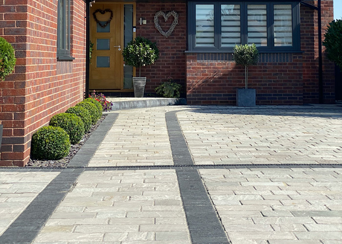 A professionally installed paver driveway by Loewen Greenhouses & Landscaping.