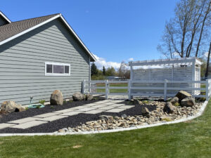 Beautiful side yard transformation featuring lush plantings, expert hardscaping, and a natural stone pathway.