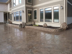 Expertly installed paver driveway with a sturdy border wall for a polished and durable finish.